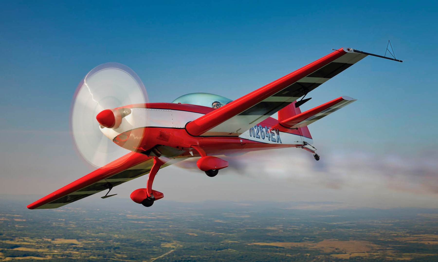 Red and white Extra 300L in flight